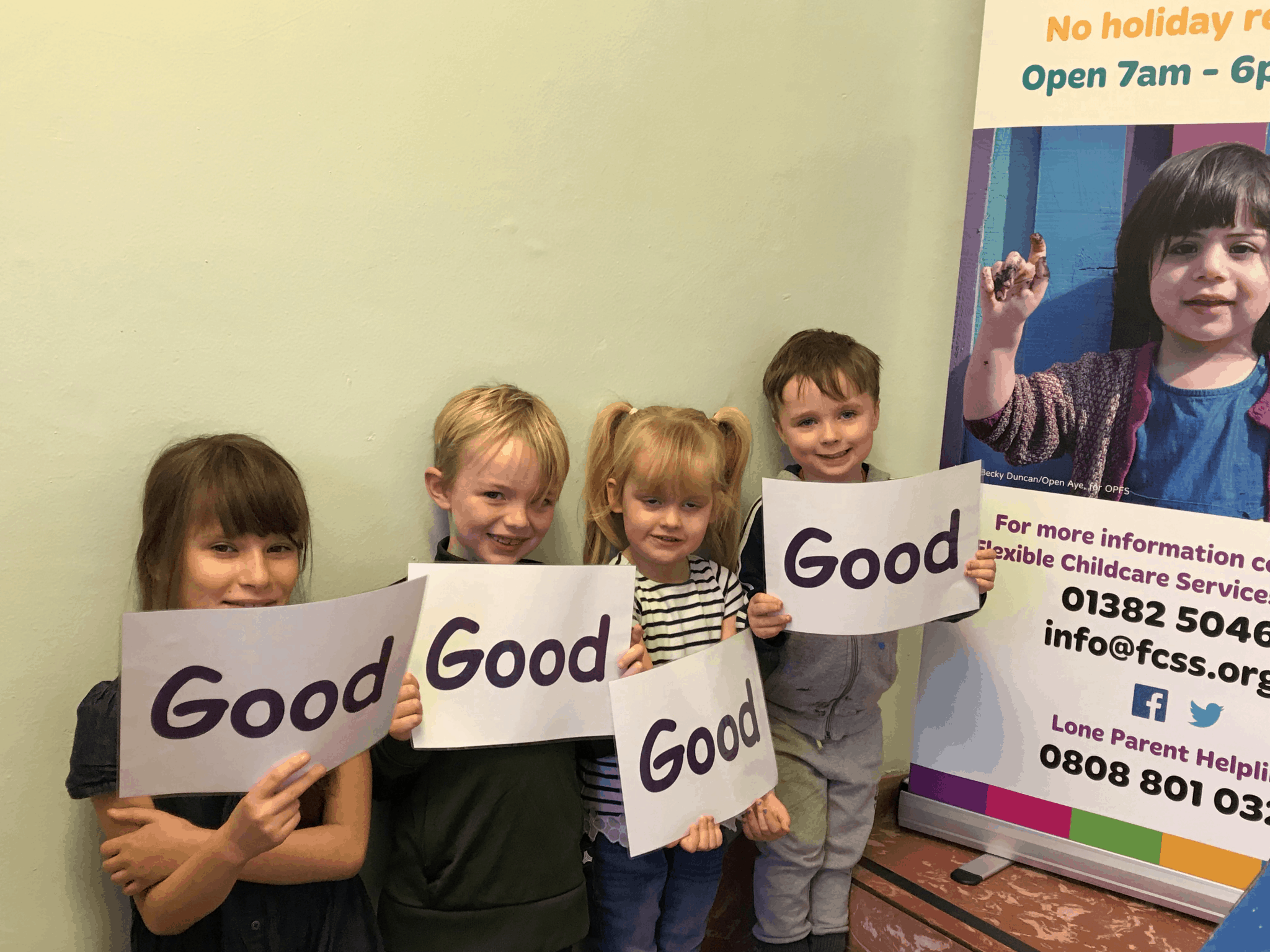 FCSS - children holding signs (Text: Good)