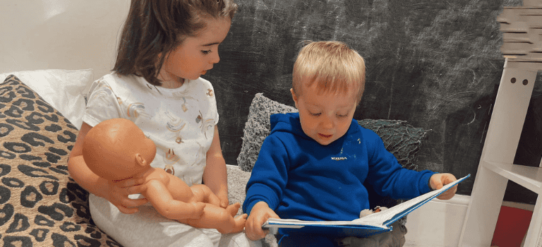 FCSS - a little boy reading a story to a friend